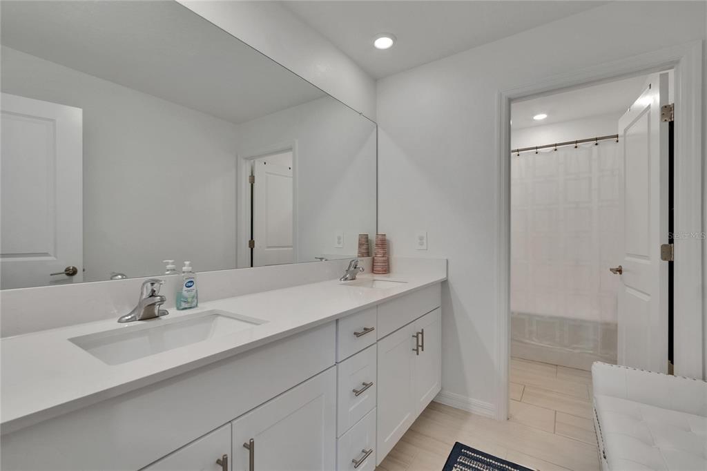 34780 Rainville Loop Zephyrhills, FL 33541 - Photo 28 of 30 a bathroom with double sink and a mirror