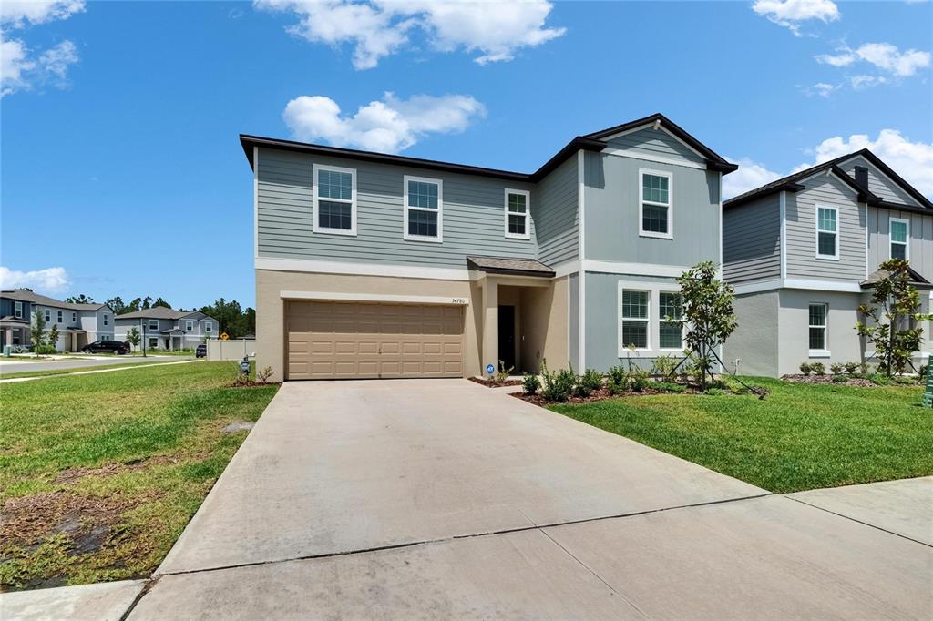 34780 Rainville Loop Zephyrhills, FL 33541 - Photo 7 of 30 a front view of a house with a yard
