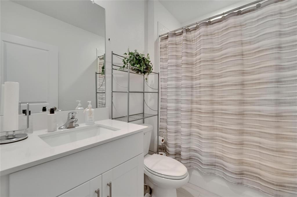 34780 Rainville Loop Zephyrhills, FL 33541 - Photo 10 of 30 a bathroom with a sink a toilet and shower