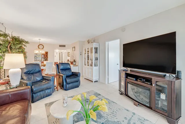 a living room with furniture a couch and a potted plant