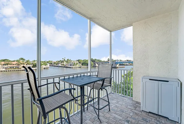 a view of a balcony with a table and chairs
