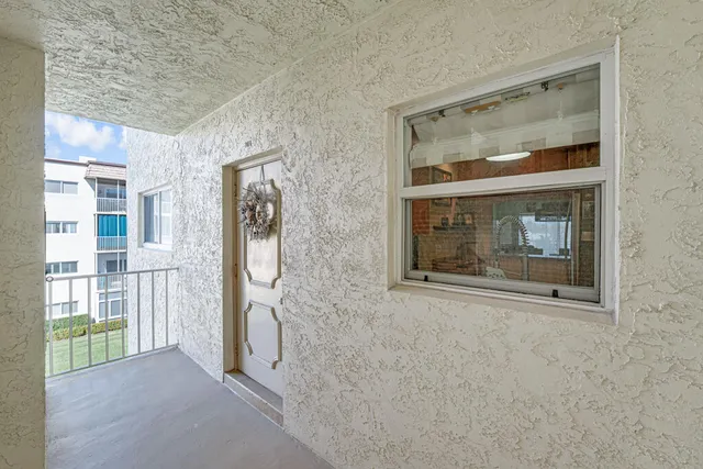 a view of kitchen island with stainless steel appliances granite countertop cabinets and sink