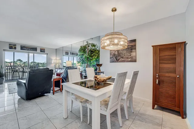 a view of a dining room with furniture and a large window