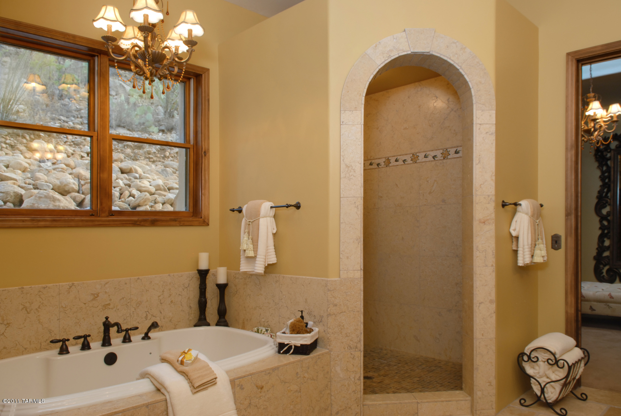 2188 East Buck Ridge Place Oro Valley, AZ 85737 - Photo 16 of 22 a bathroom with a tub sink and mirror