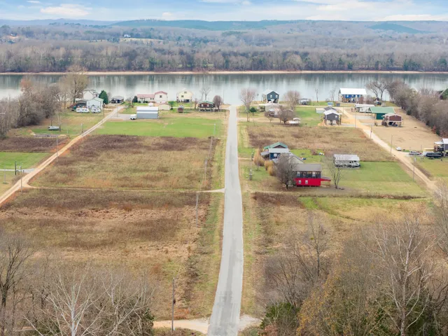 a view of a lake with a table and chairs