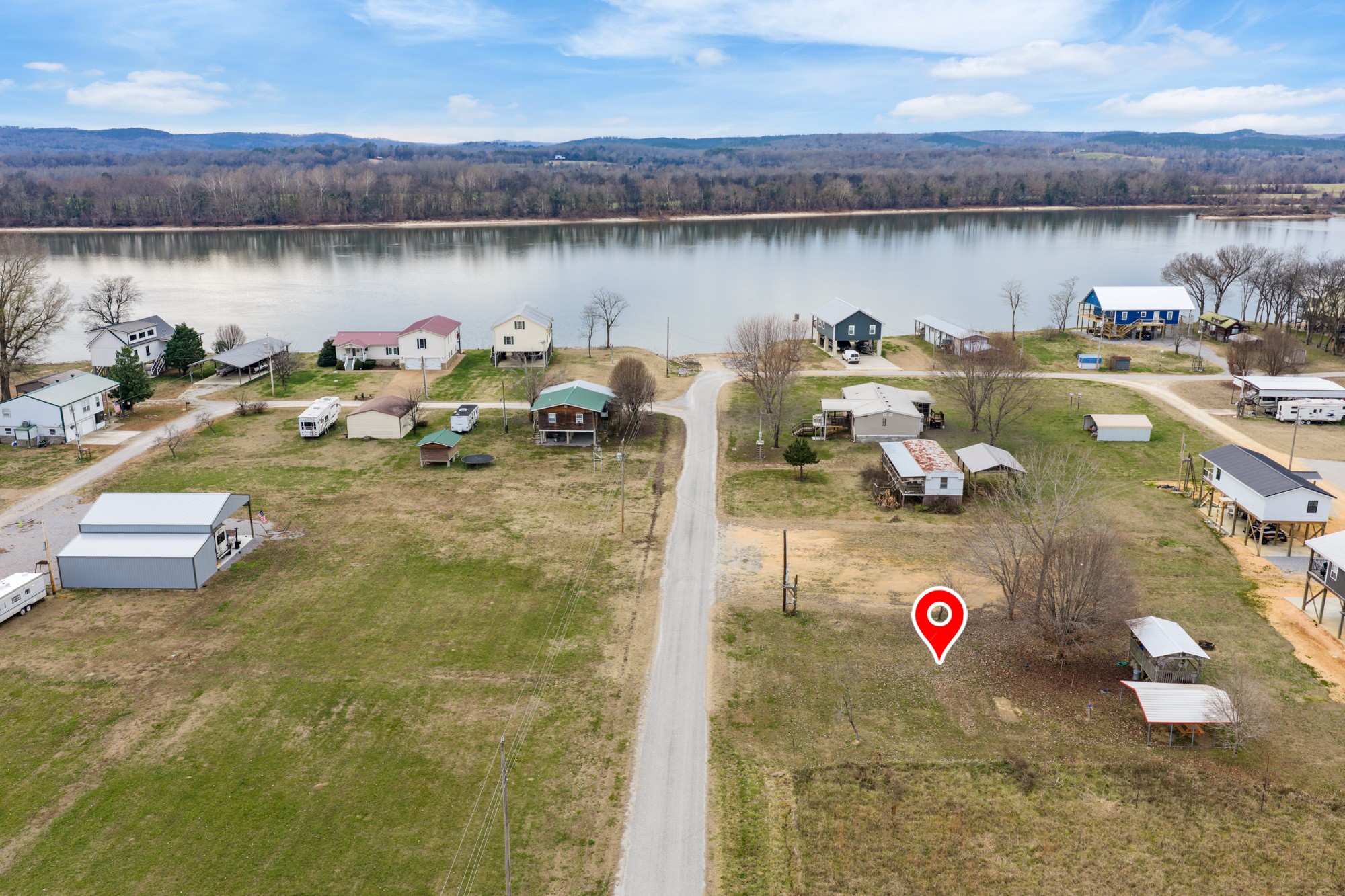 0 Eagle Bend Road Linden, TN 37096 - Photo 3 of 26 a view of a lake with a table and chairs