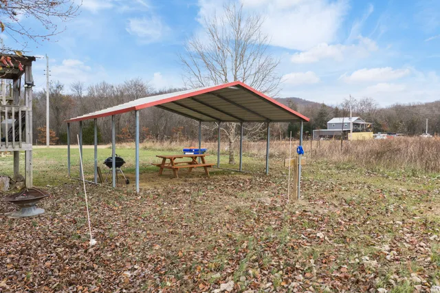 a backyard of a house with table and chairs