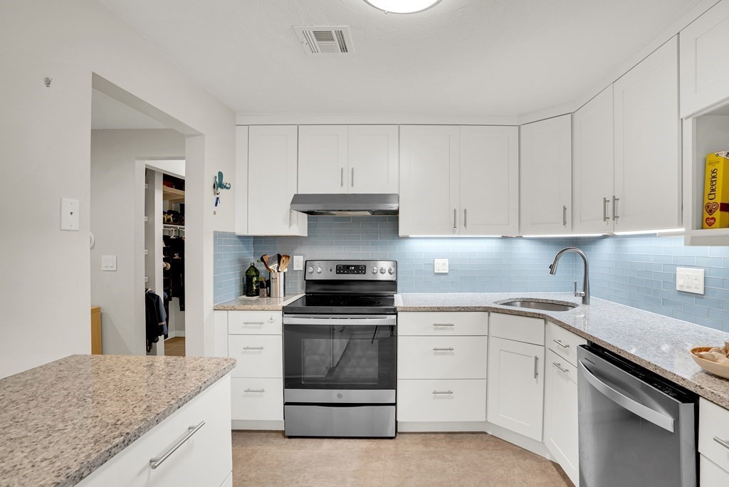 214 Ridgefield Circle, Unit B Clinton, MA 01510 - Photo 14 of 32 a kitchen with white cabinets stainless steel appliances and sink