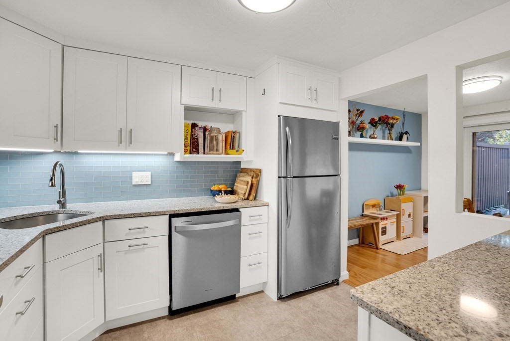 214 Ridgefield Circle, Unit B Clinton, MA 01510 - Photo 15 of 32 a kitchen with stainless steel appliances granite countertop a refrigerator a sink and white cabinets
