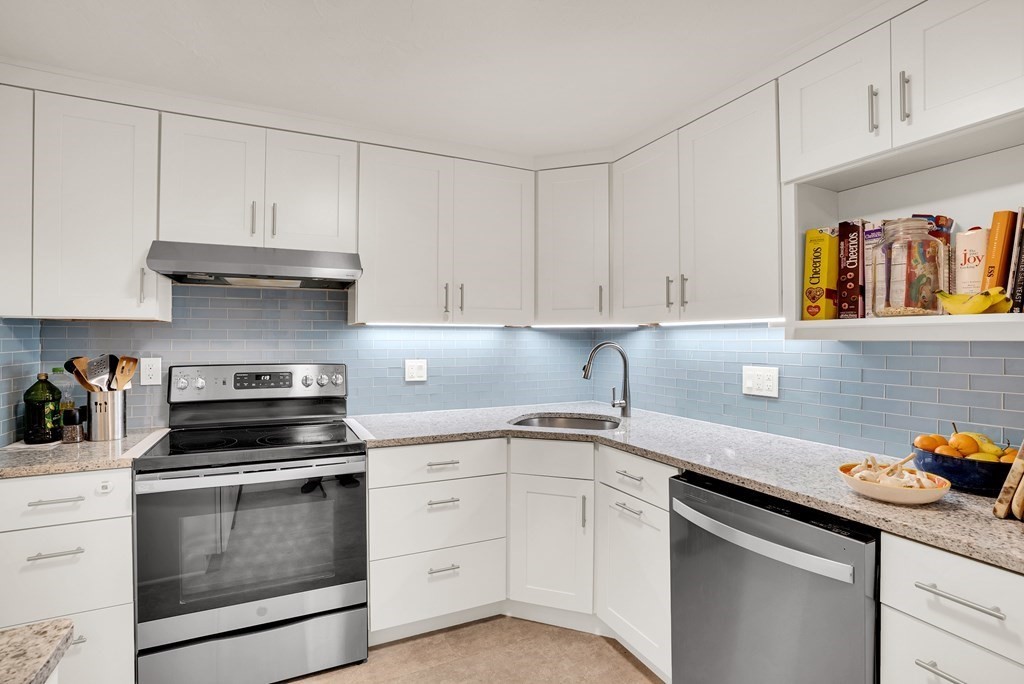214 Ridgefield Circle, Unit B Clinton, MA 01510 - Photo 17 of 32 a kitchen with granite countertop white cabinets and stainless steel appliances