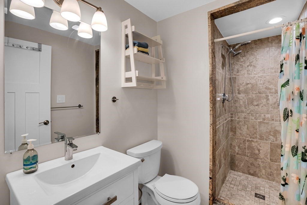 214 Ridgefield Circle, Unit B Clinton, MA 01510 - Photo 21 of 32 a bathroom with a sink a toilet and shower