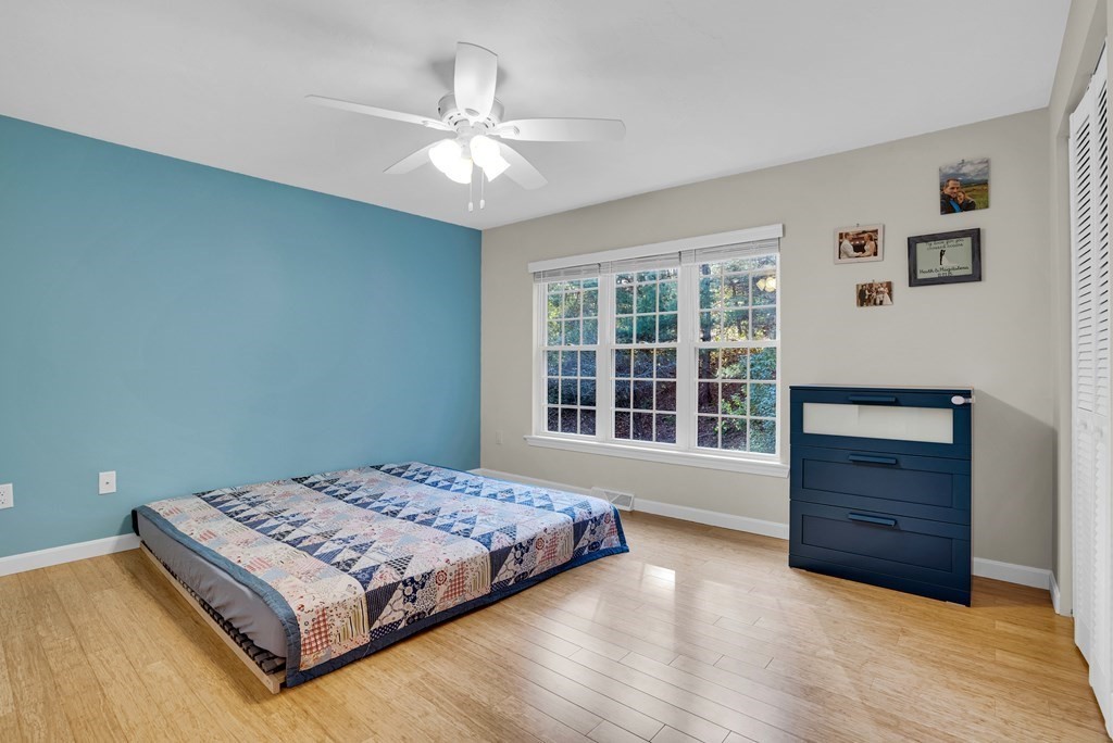 214 Ridgefield Circle, Unit B Clinton, MA 01510 - Photo 27 of 32 a bedroom with a bed and a window