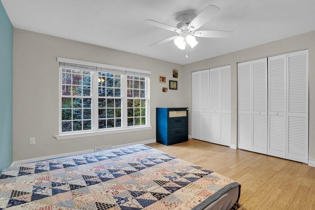 214 Ridgefield Circle, Unit B Clinton, MA 01510 - Photo 29 of 32 a view of a bedroom with wooden floor and window