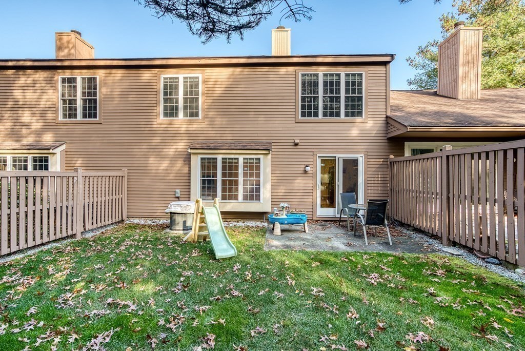 214 Ridgefield Circle, Unit B Clinton, MA 01510 - Photo 32 of 32 front view of a house with a yard and furniture