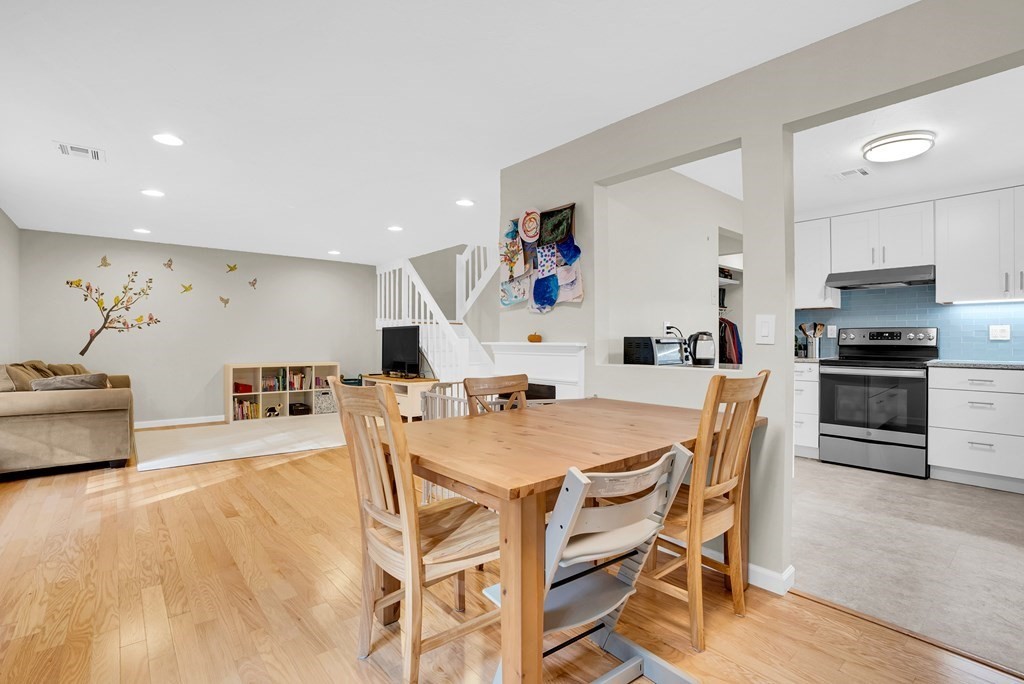 214 Ridgefield Circle, Unit B Clinton, MA 01510 - Photo 10 of 32 a kitchen with stainless steel appliances kitchen island granite countertop a dining table chairs and a refrigerator