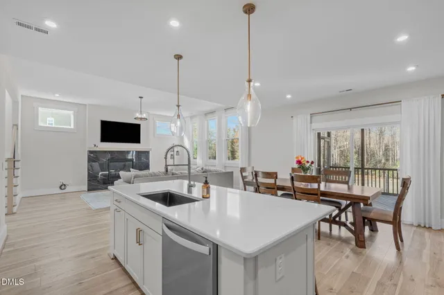 a large kitchen with kitchen island a sink table and chairs