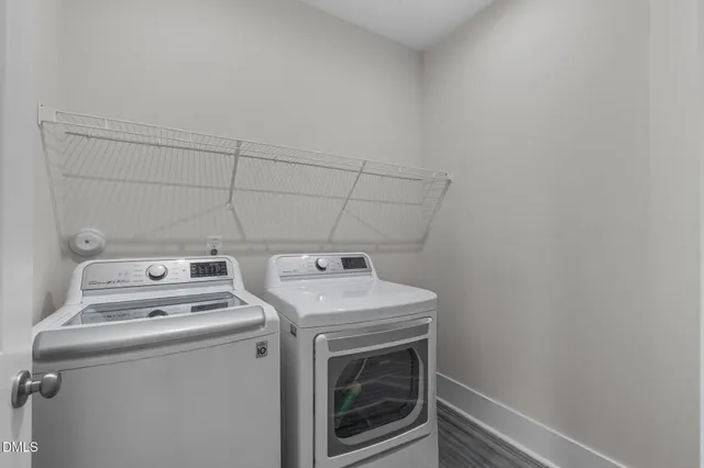a view of an empty room and chandelier fan
