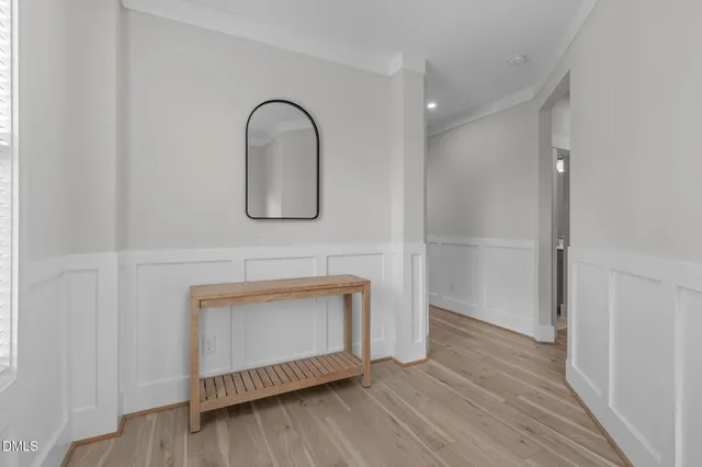 a living room with furniture a flat screen tv and a large window
