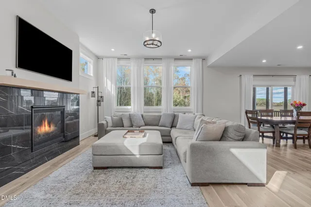 a living room with furniture and kitchen view