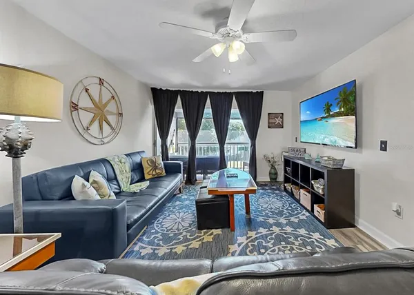 a living room with furniture a rug and a window