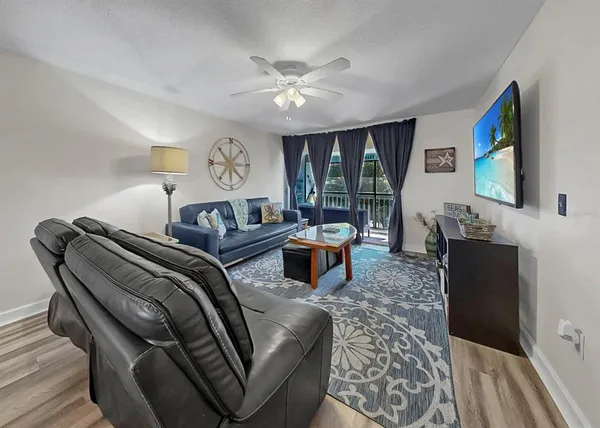 a living room with furniture a rug and a chandelier