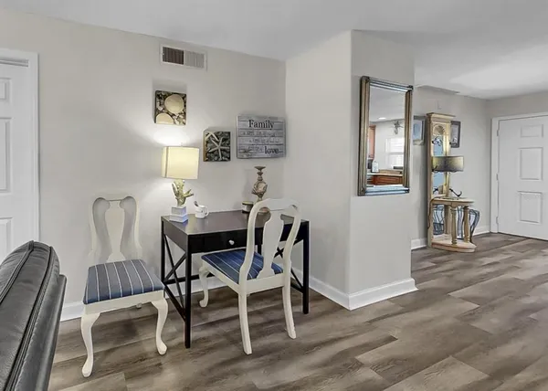 a bedroom with a bed and a flat tv screen on a dresser