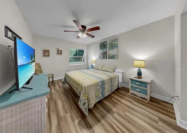 a bedroom with a bed and a flat screen tv