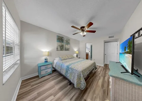 a bedroom with a bed and a chandelier