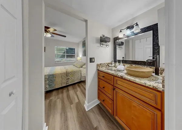 a spacious bathroom with a granite countertop sink toilet and shower