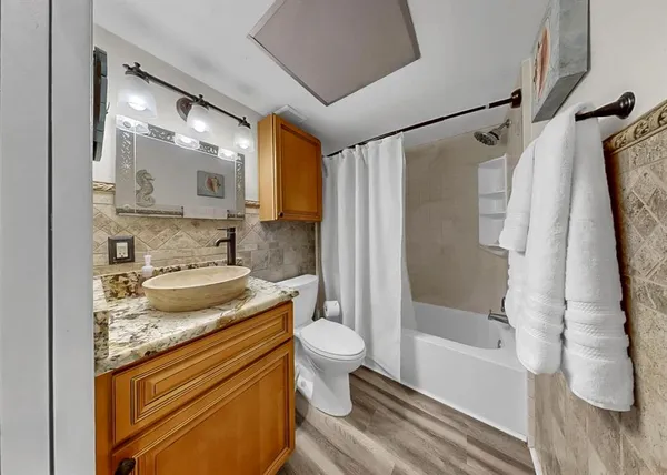 a white toilet sitting next to a bathroom sink