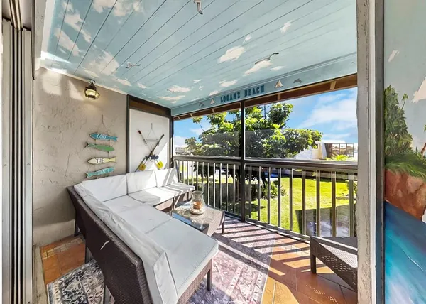 a living room with furniture and floor to ceiling window