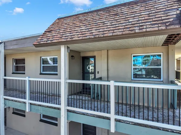 a dining room with wooden floor a chandelier a wooden table and chairs