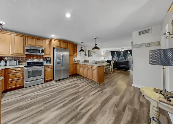 a kitchen with stainless steel appliances granite countertop a stove and a refrigerator