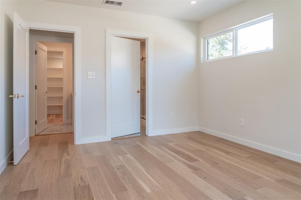 210 Davis Road Granbury, TX 76049 - Photo 11 of 28 an empty room with wooden floor and windows