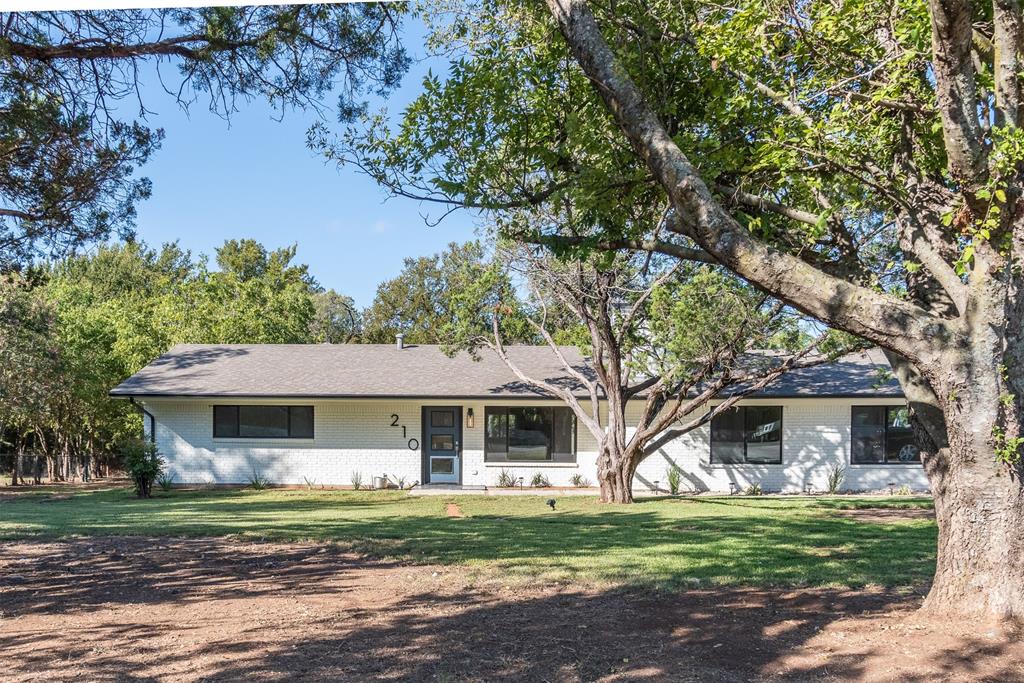 210 Davis Road Granbury, TX 76049 - Photo 2 of 28 a front view of a house with a garden