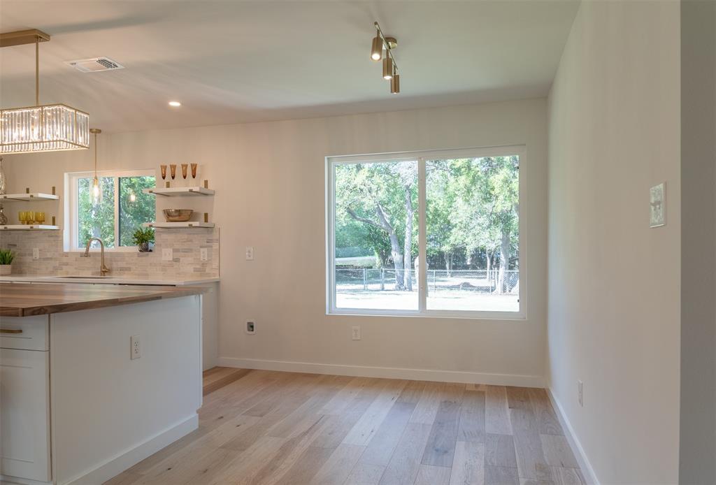 210 Davis Road Granbury, TX 76049 - Photo 22 of 28 a view of kitchen and center island in wooden floor