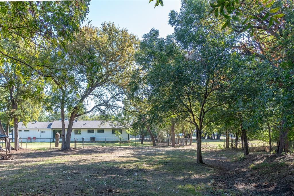 210 Davis Road Granbury, TX 76049 - Photo 6 of 28 a view of a house with a tree in front