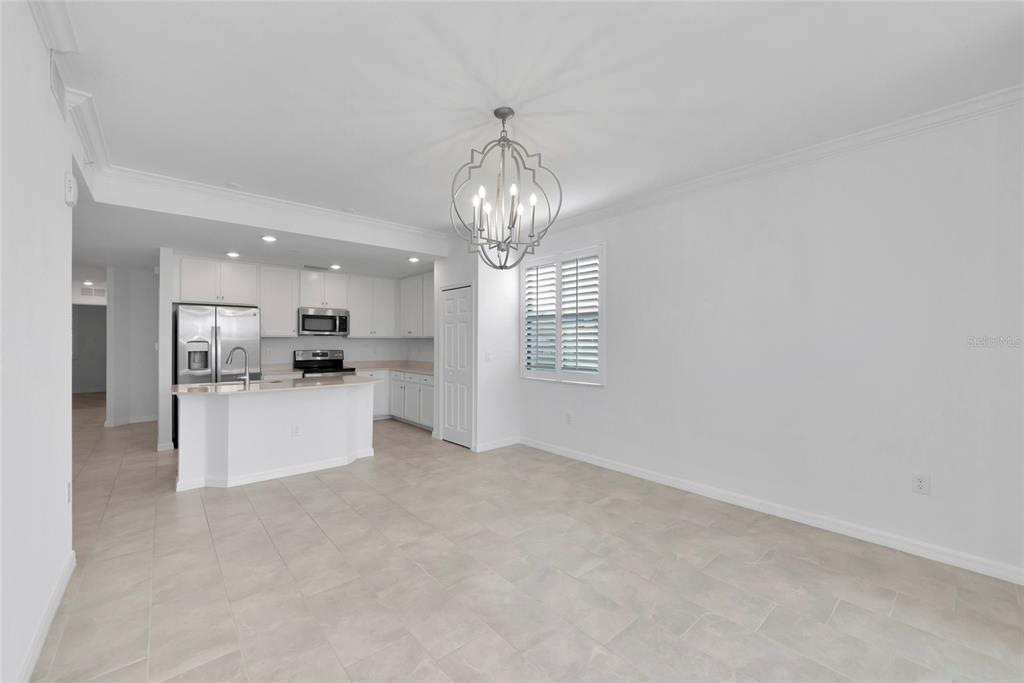 18008 Gawthrop Drive, Unit 101 Lakewood Ranch, FL 34211 - Photo 17 of 56 a view of a big room with windows and chandelier