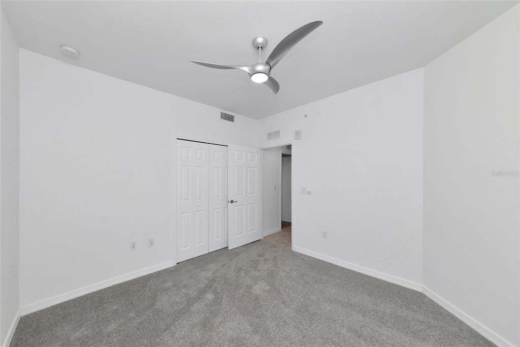 18008 Gawthrop Drive, Unit 101 Lakewood Ranch, FL 34211 - Photo 28 of 56 an empty room with a ceiling fan and a ceiling fan