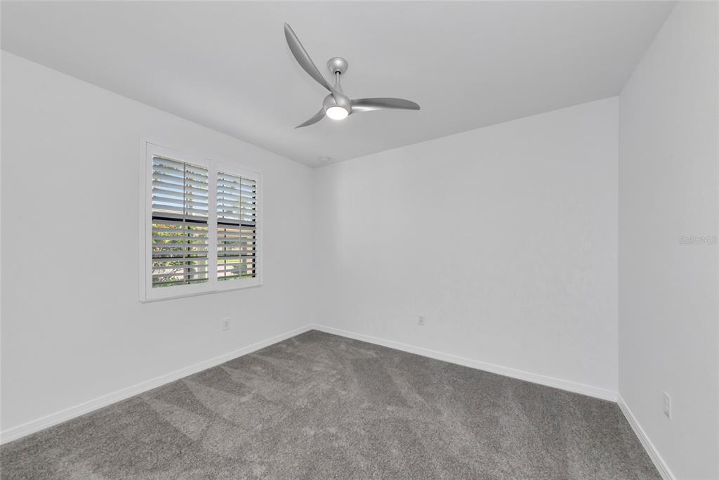 18008 Gawthrop Drive, Unit 101 Lakewood Ranch, FL 34211 - Photo 33 of 56 an empty room with a window and ceiling fan