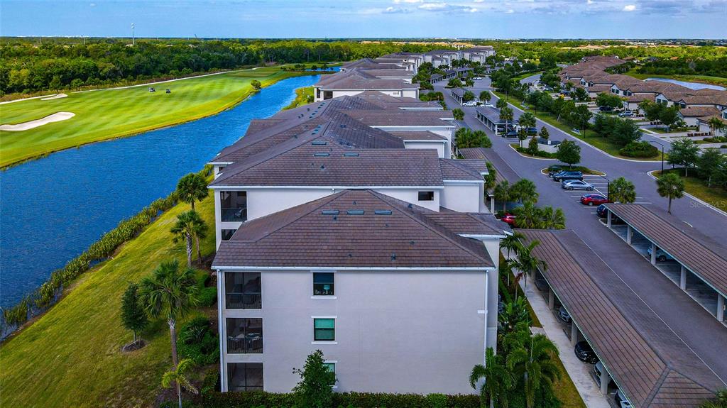 18008 Gawthrop Drive, Unit 101 Lakewood Ranch, FL 34211 - Photo 44 of 56 an aerial view of a house with a yard and lake view