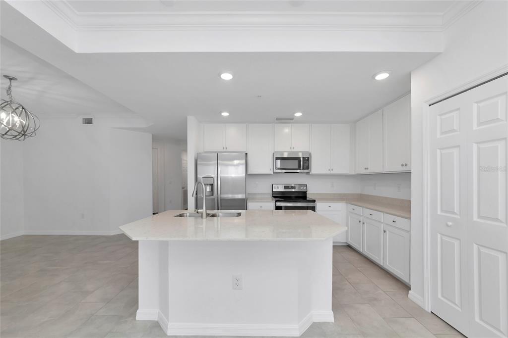 18008 Gawthrop Drive, Unit 101 Lakewood Ranch, FL 34211 - Photo 9 of 56 a kitchen with stainless steel appliances a sink stove and cabinets
