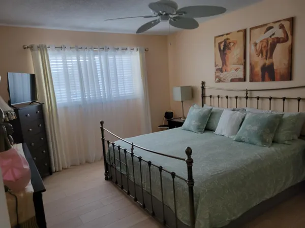 a bedroom with a bed and a chandelier