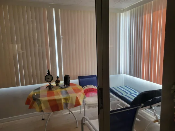 a dining room with furniture and a window