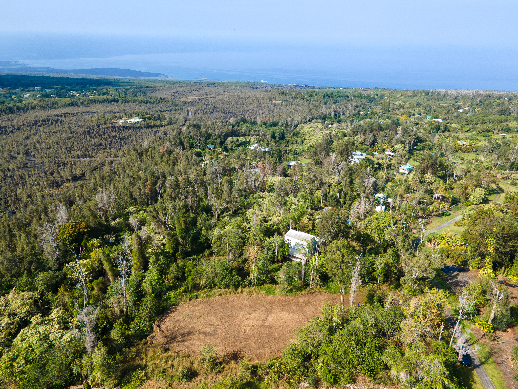 89-806 Lot 28 Huanui Road Captain Cook, HI 96704 - Photo 14 of 16 a view of a city with lush green forest
