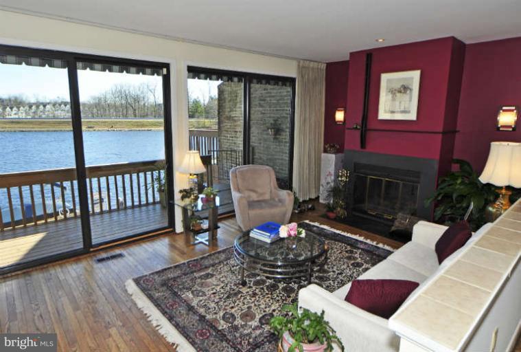 2011 Lakewinds Drive Reston, VA 20191 - Photo 10 of 26 The living room has a fireplace & lake views.