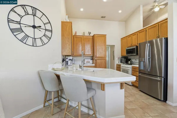 a kitchen with a sink dining table and chairs