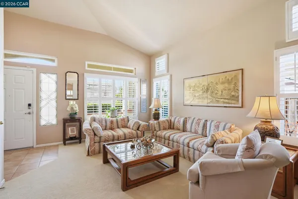 a living room with furniture fireplace and a large window