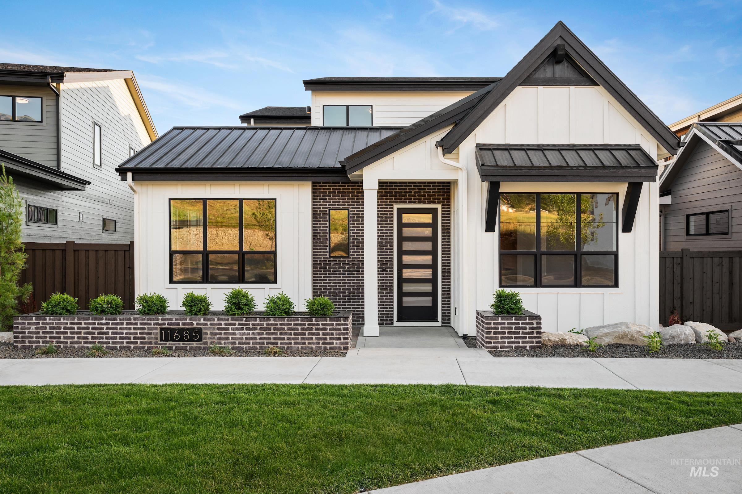 11685 North Rabbitbrush Way Boise, ID 83714 - Photo 1 of 35 Modern farmhouse with a standing seam roof, a metal roof, board and batten siding, and brick siding