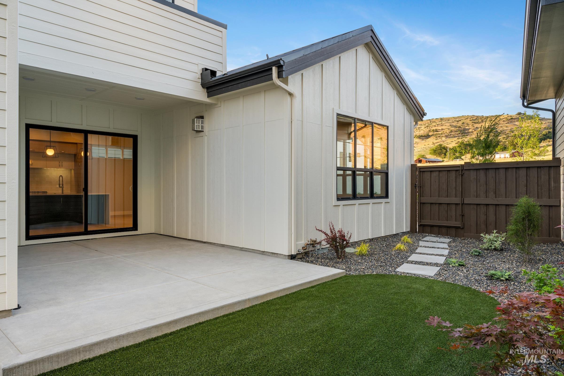11685 North Rabbitbrush Way Boise, ID 83714 - Photo 12 of 35 Rear view of house with board and batten siding and a patio